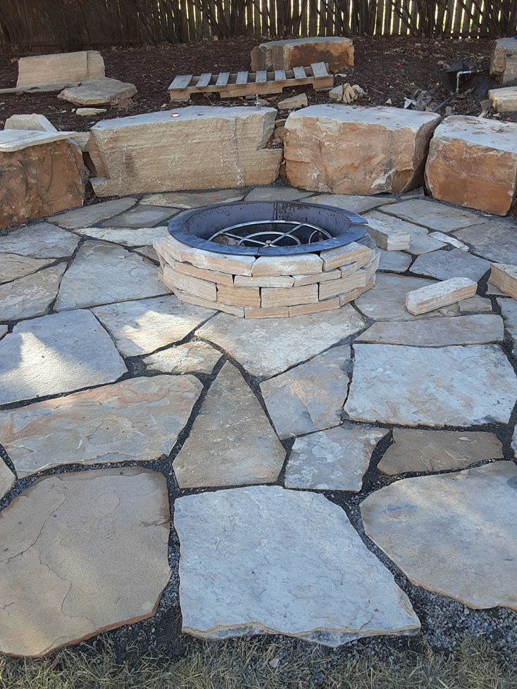 Fort Collins hardscape design flagstone patio with stone firepit