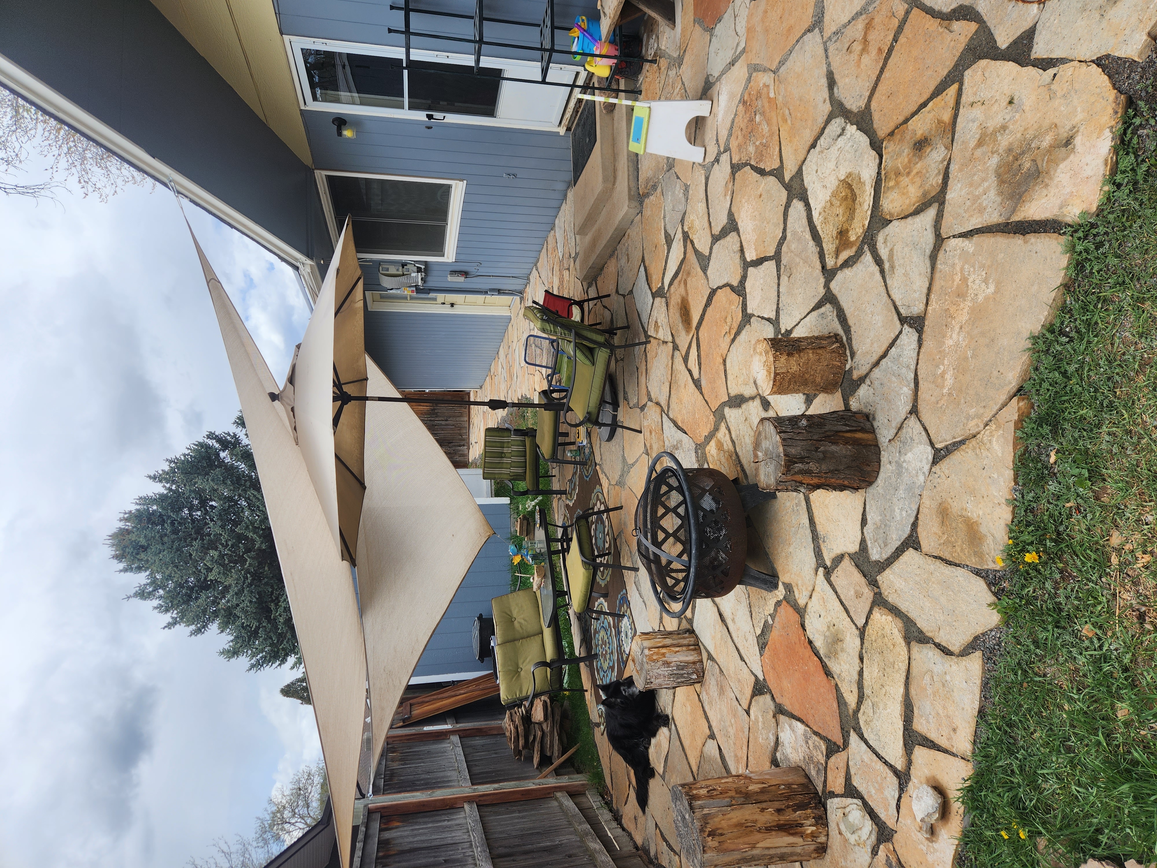 A Fort Collins home with a stone patio and sun shades