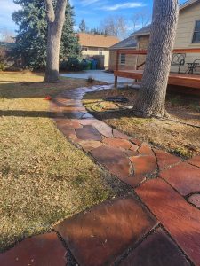 A red flagstone walkway in a yard in Fort Collins