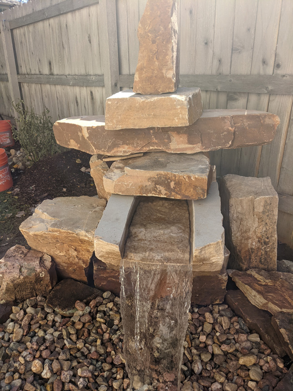 Stone backyard water feature install in Fort Collins by Linden Leaf Landscapes