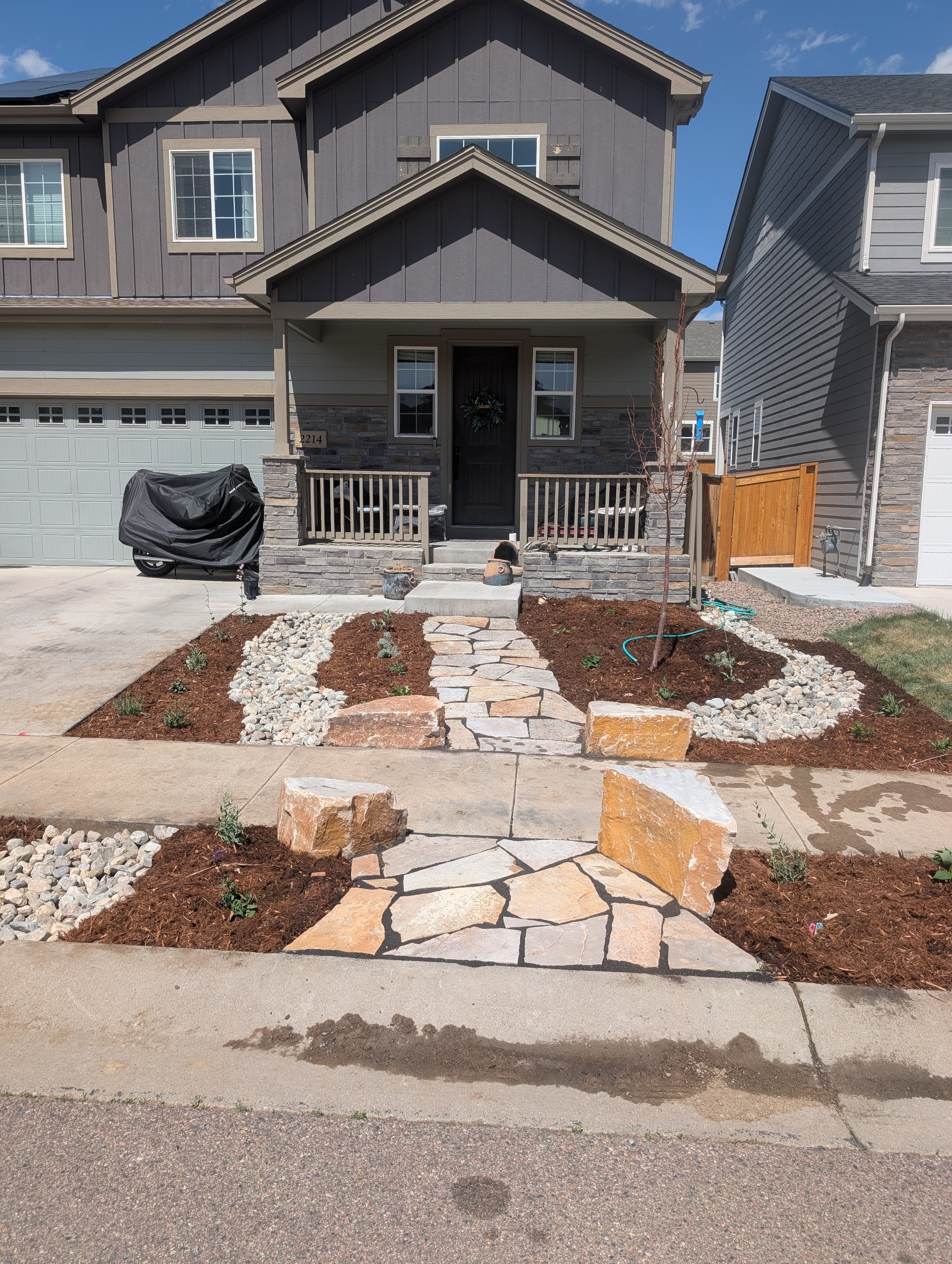Front yard xeriscape design in Fort Collins with mulch and stone pathways