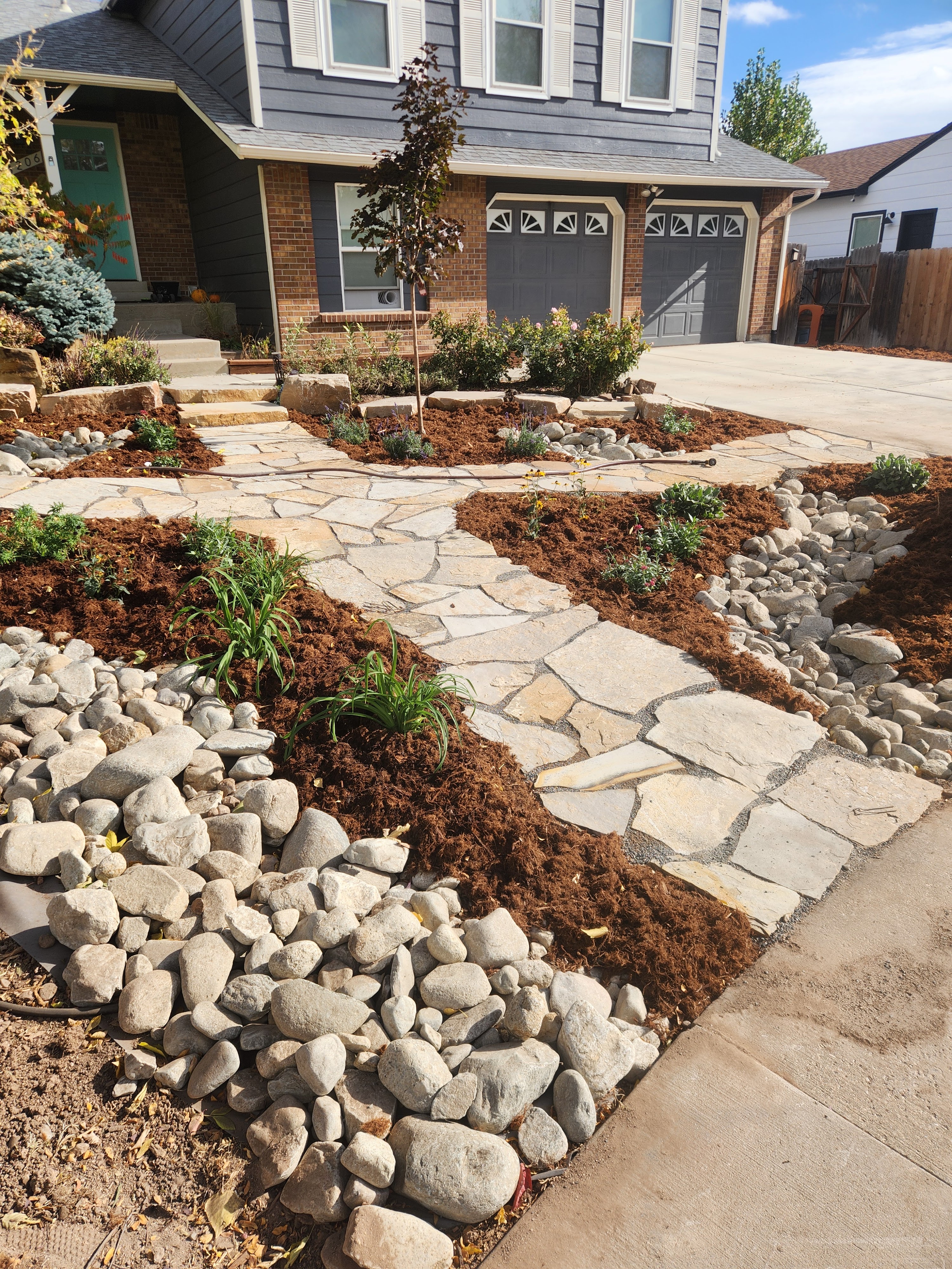 Colorado xeriscape design by Linden Leaf Landscapes with rock pathways and mulch