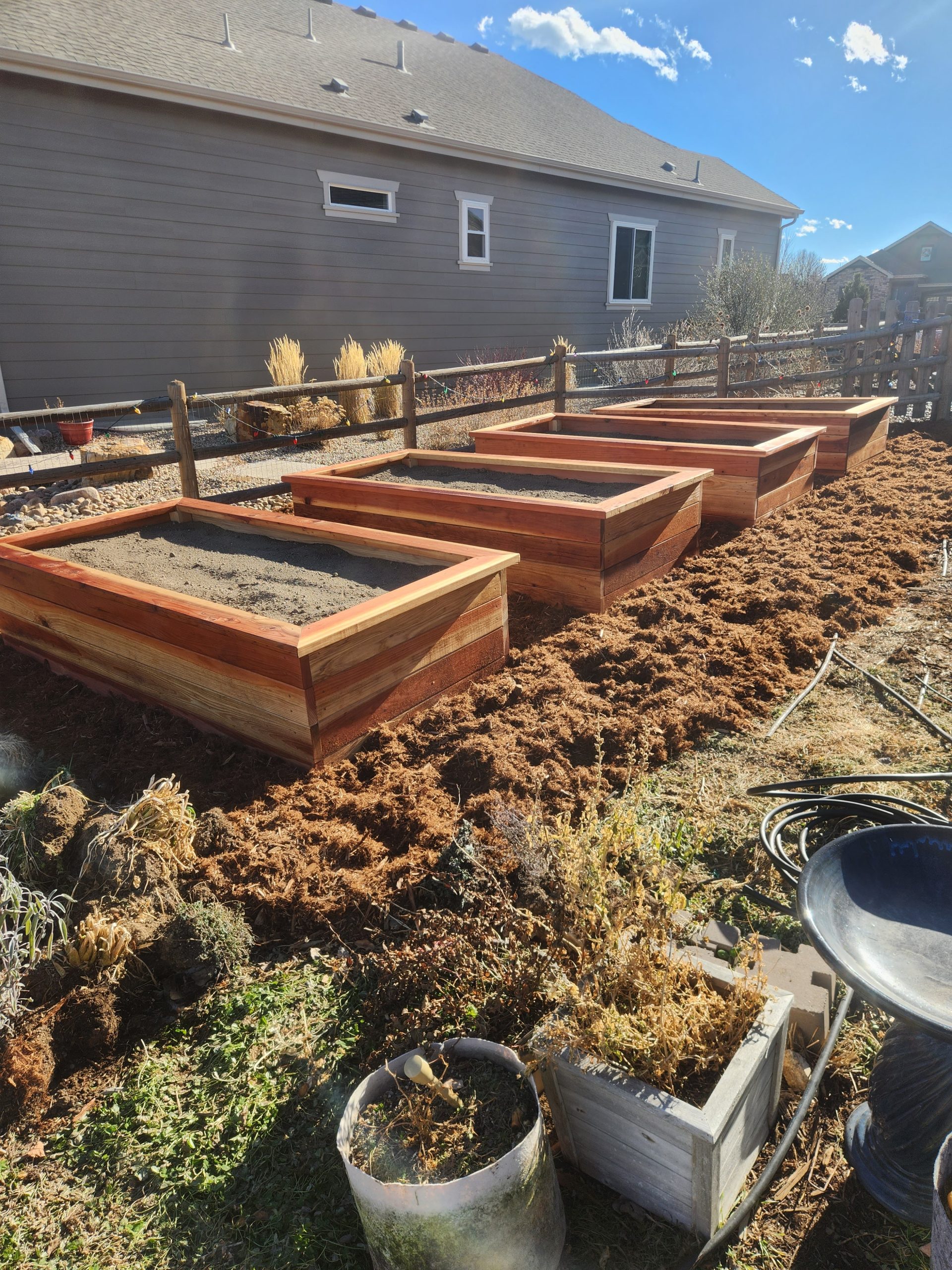 Natural stone brick planter beds on gravel in a Fort Collins yard