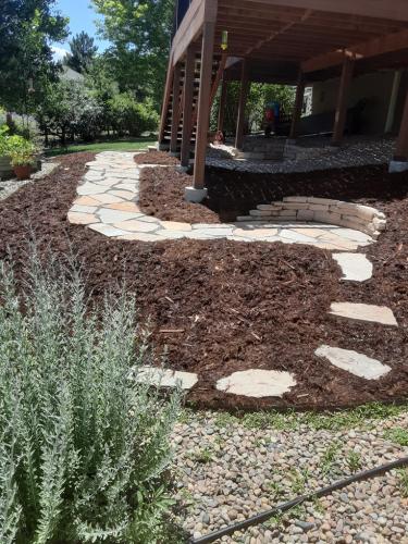 Stone pathway in mulch bed in Fort Collins