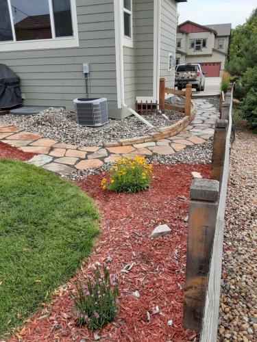 Landscape design red mulch with stone pathway in Fort Collins, CO