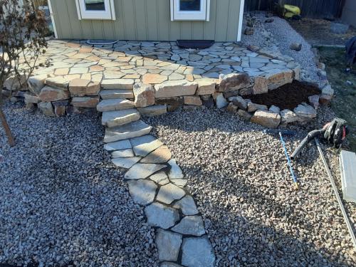 Hardscape design rock bed and stone patio in Fort Collins, CO