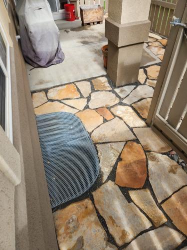 Stone patio space surrounding window well in Colorado