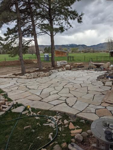 Large flagstone patio with rocky mountains in the background