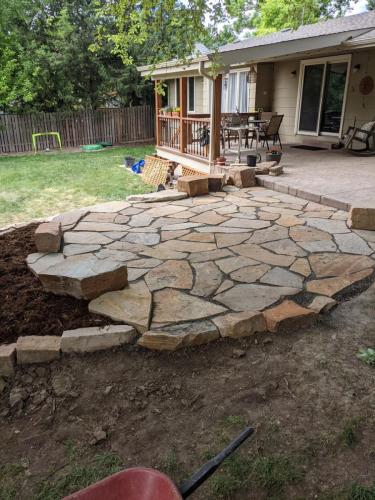 Flagstone patio with grass yard and mulch
