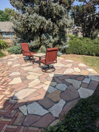 Outdoor furniture on new hardscape stone patio