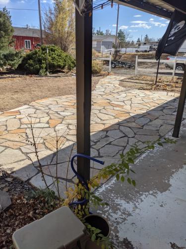 Covered patio with walkout to stone patio in Fort Collins