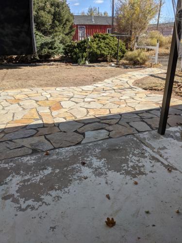 Covered patio with step to flagstone patio in Fort Collins