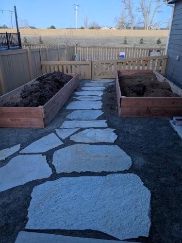 Large stone pathway between garden beds in Fort Collins