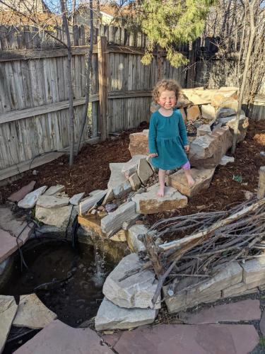 A child standing on a hardscape design in Fort Collins