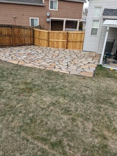 A custom stone patio made of flagstone by Linden Leaf Landscapes in Fort Collins