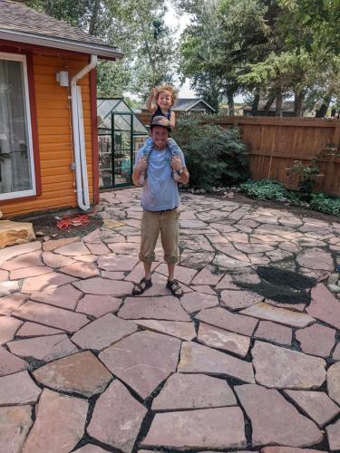 Linden Hunter standing on one of his custom stone patio designs in Fort Collins