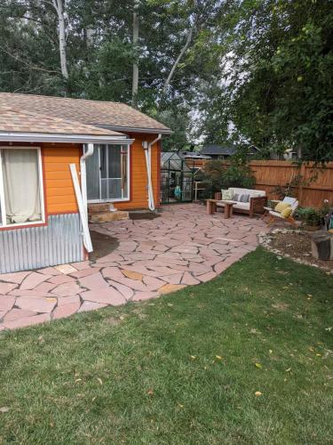 Beautiful custom stone patio wrapped around a house in Fort Collins