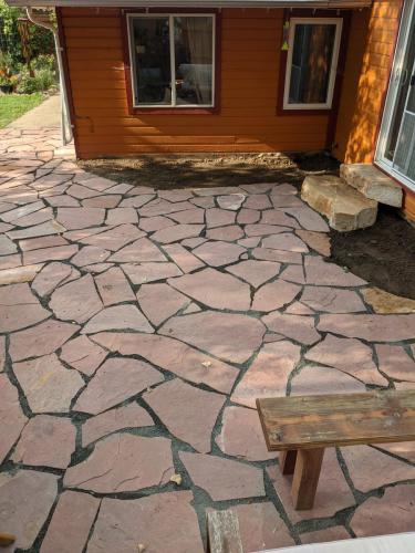 Large red flagstone patio design in Northern Colorado by Linden Leaf Landscapes