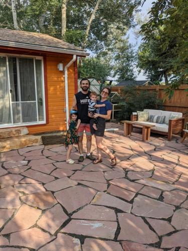 Satisfied customers of Linden Leaf Landscapes pose for a family photo on their new flagstone patio