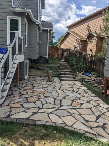 Staircase with stone patio in a Fort Collins backyard