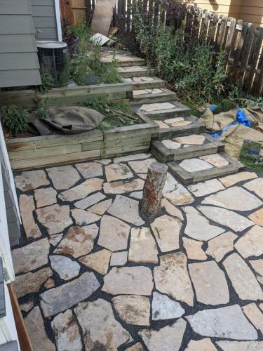 Stone patio with flagstone step stones and retaining walls in Fort Collins