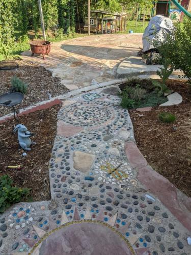 Intricate stonework decision with artwork in pathway in Colorado 