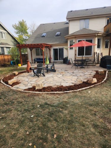 Stone patio with mulch border xeriscape design in Fort Collins