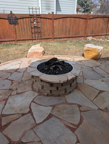 Flagstone patio with fire pit by Linden Leaf Landscapes