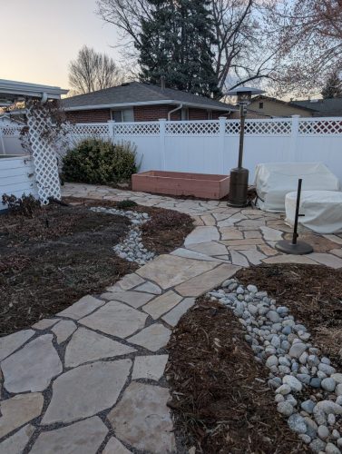 Fort Collins xeriscape with brown mulch and stone pathways